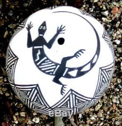 Acoma seed pot by Lucario with black on white geometrics and lizard around hole